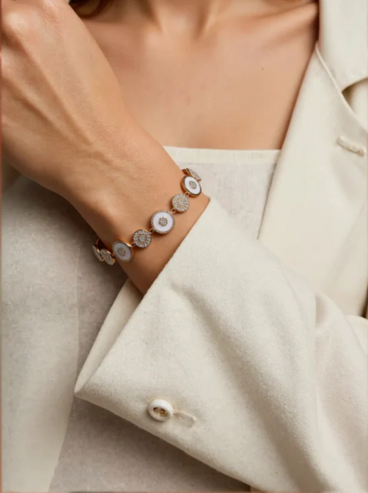 Close-up of a person wearing a bracelet with a neutral background
